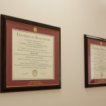 Dentist awards displayed on wall